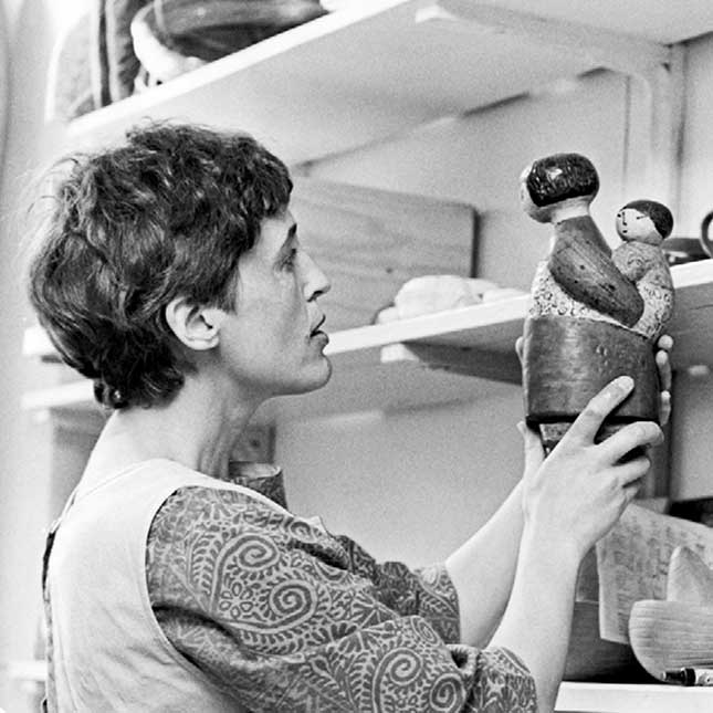 Lisa Larson inspecting the Japanese woman figurine