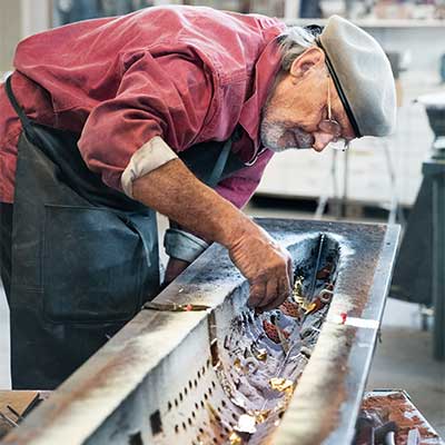 Bertil Vallien with sand casting mold and symbolic objects