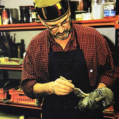 Bertil Vallien is touching-up on a sand-casted head